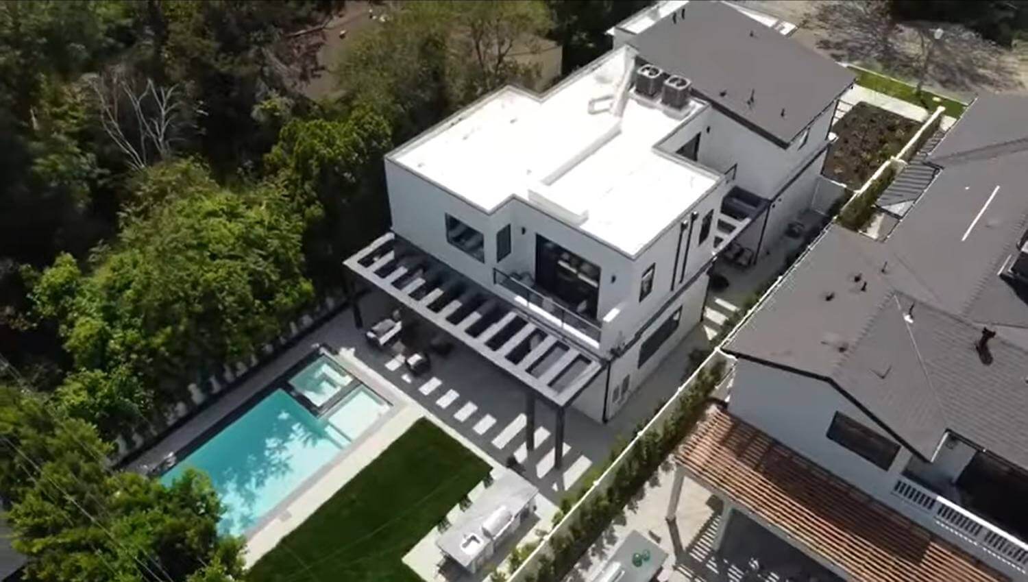 Aerial view of a multi-story home and swimming pool